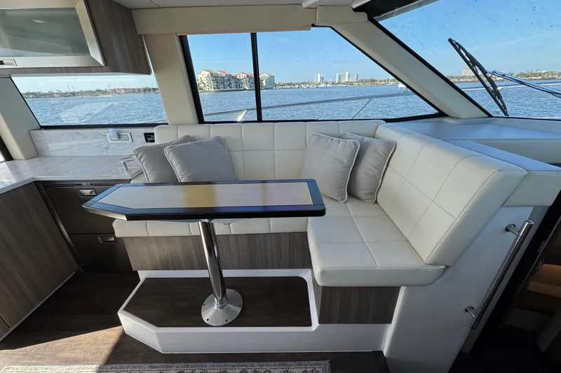 Irresistible Yacht Photos Pics Luxurious interior of 2021 Regal 38 XO yacht with elegant seating and scenic water view.