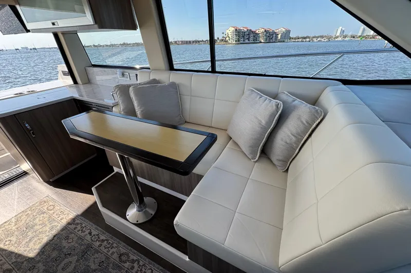 Irresistible Yacht Photos Pics Luxurious interior of 2021 Regal 38 XO yacht with white seating and scenic water view.