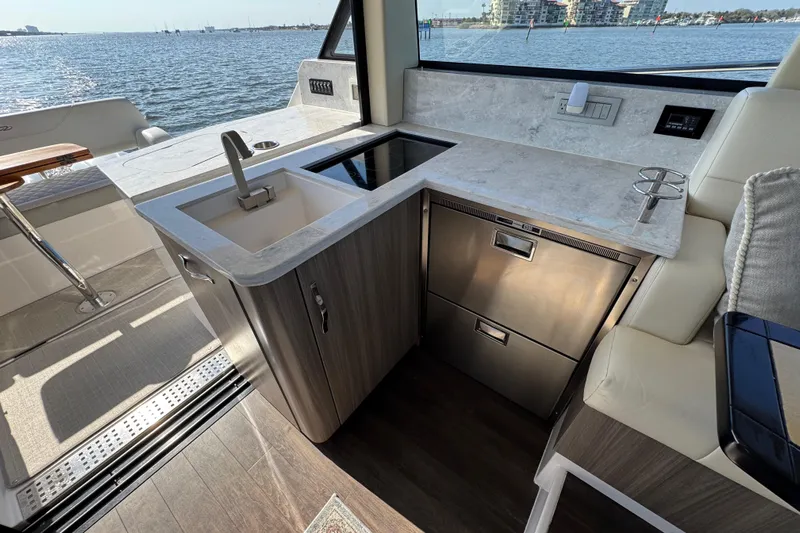 Irresistible Yacht Photos Pics Luxurious 2021 Regal 38 XO yacht interior with modern kitchenette and scenic ocean view.