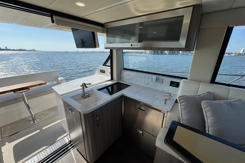 Irresistible Yacht Photos Pics Luxurious interior of 2021 Regal 38 XO yacht with modern kitchen and ocean view.