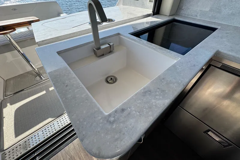 Irresistible Yacht Photos Pics Luxury yacht kitchen with modern sink and stovetop, Regal 38 XO, 2021 model.