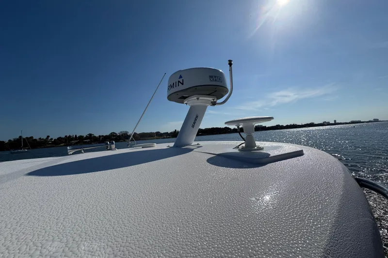 Irresistible Yacht Photos Pics 2021 Regal 38 XO boat with Garmin radar on sunny day, ocean view.