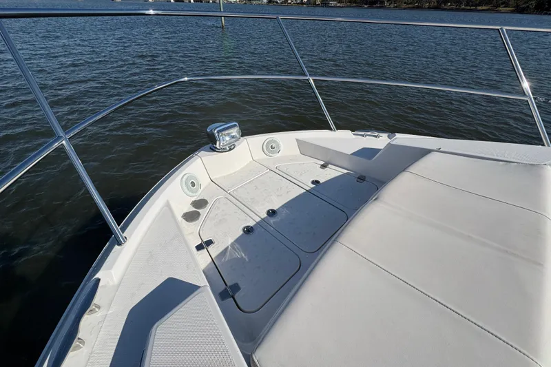Irresistible Yacht Photos Pics Bow view of 2021 Regal 38 XO yacht with sleek deck design.
