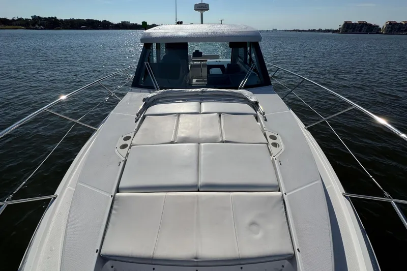 Irresistible Yacht Photos Pics 2021 Regal 38 XO yacht with sunpad on calm water.