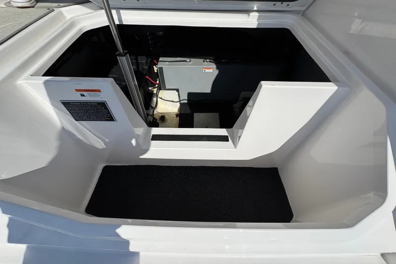 Irresistible Yacht Photos Pics 2021 Regal 38 XO boat storage compartment with open hatch and visible equipment.