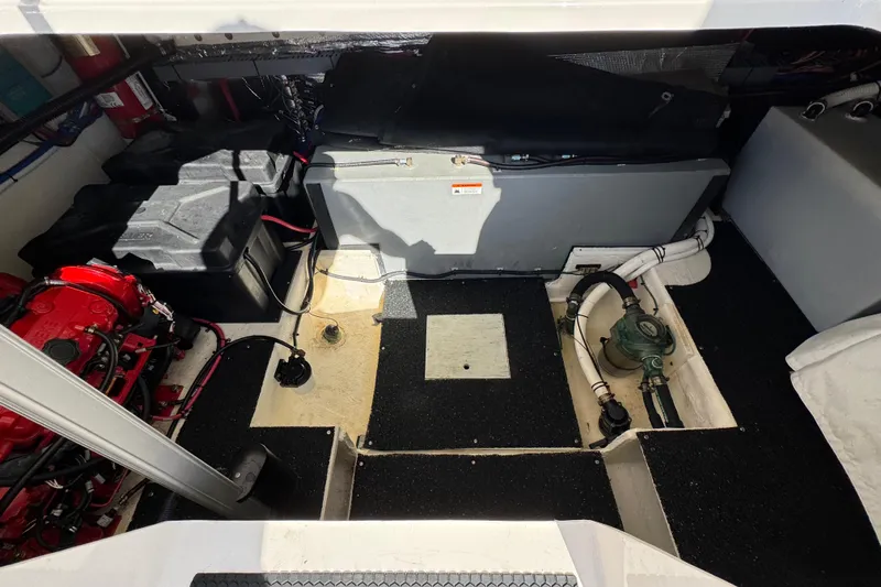 Irresistible Yacht Photos Pics Engine compartment of 2021 Regal 38 XO boat, showcasing mechanical components and wiring.