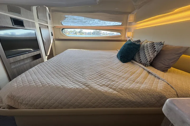 Irresistible Yacht Photos Pics Luxurious cabin interior of 2021 Regal 38 XO yacht with cozy bed and modern decor.