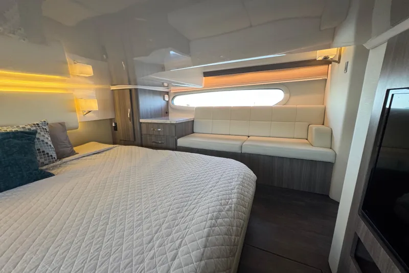 Irresistible Yacht Photos Pics Luxurious interior of 2021 Regal 38 XO yacht with bed and seating area.