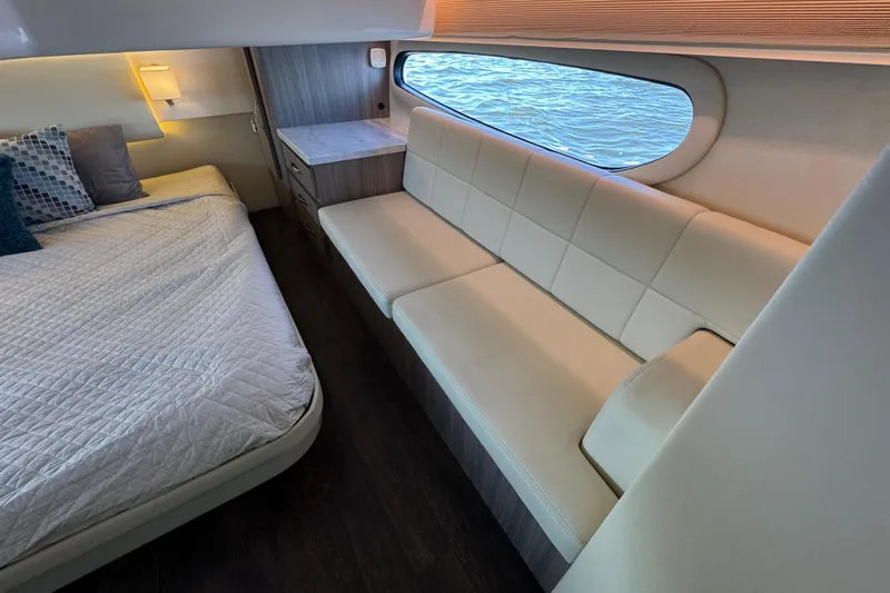 Irresistible Yacht Photos Pics Luxurious interior of 2021 Regal 38 XO yacht with bed and seating area.