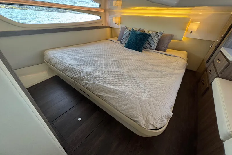 Irresistible Yacht Photos Pics Luxurious cabin interior of 2021 Regal 38 XO yacht with cozy bed and elegant decor.