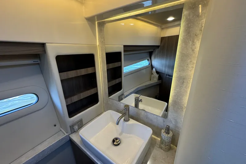 Irresistible Yacht Photos Pics Luxurious bathroom interior of 2021 Regal 38 XO yacht with modern sink and mirror.