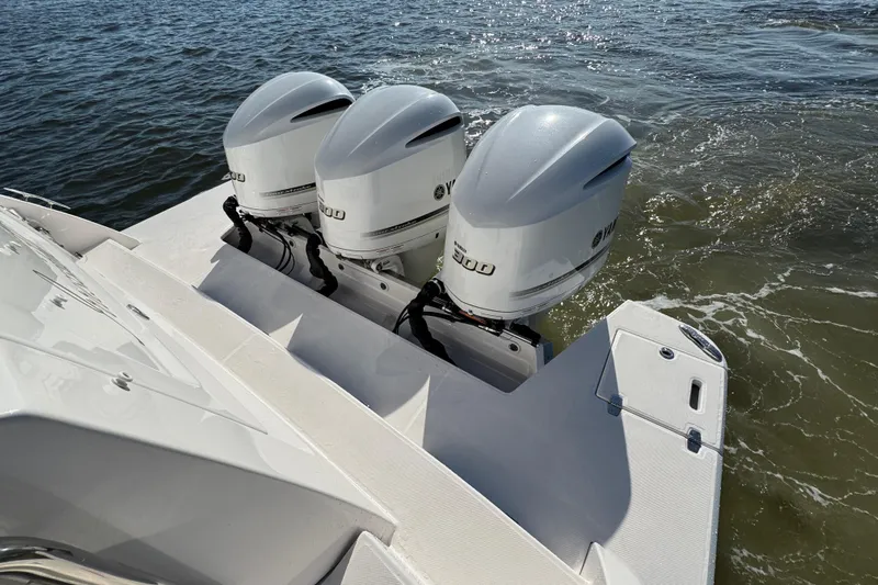 Irresistible Yacht Photos Pics Triple Yamaha outboard engines on a 2021 Regal 38 XO boat in water.