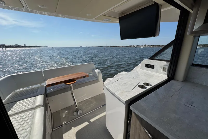 Irresistible Yacht Photos Pics Interior view of 2021 Regal 38 XO yacht with ocean backdrop.