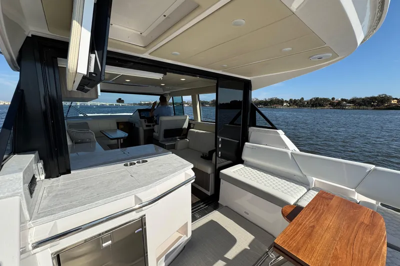 Irresistible Yacht Photos Pics 2021 Regal 38 XO yacht interior with modern seating and scenic water view.