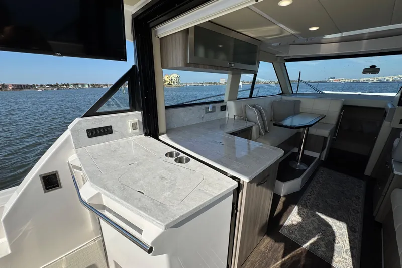 Irresistible Yacht Photos Pics Luxurious interior of 2021 Regal 38 XO yacht with modern kitchen and seating area.