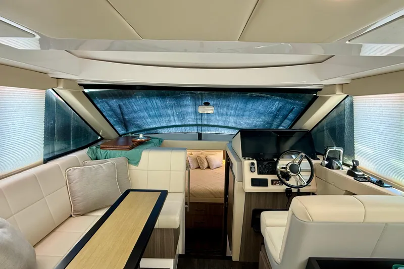 Irresistible Yacht Photos Pics Interior of 2021 Regal 38 XO yacht with modern helm and seating area.