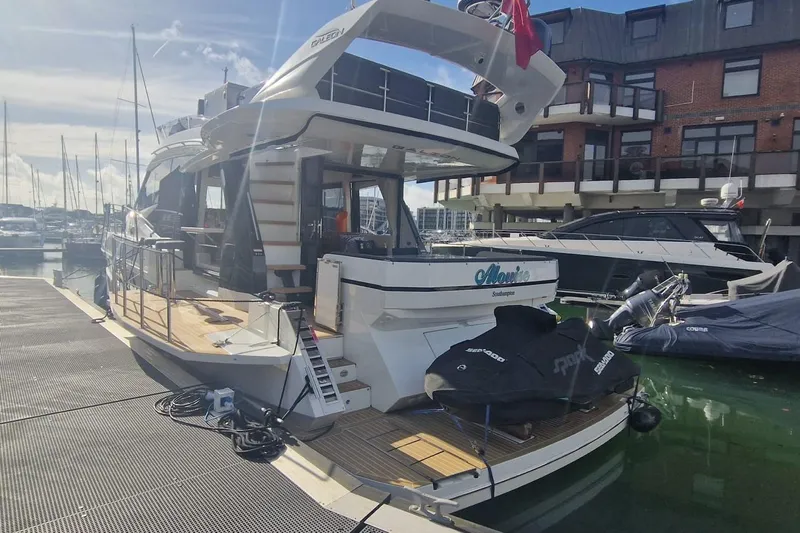 Alouise Yacht Photos Pics 2022 Galeon 460 Fly yacht docked at marina, featuring modern design and spacious deck.