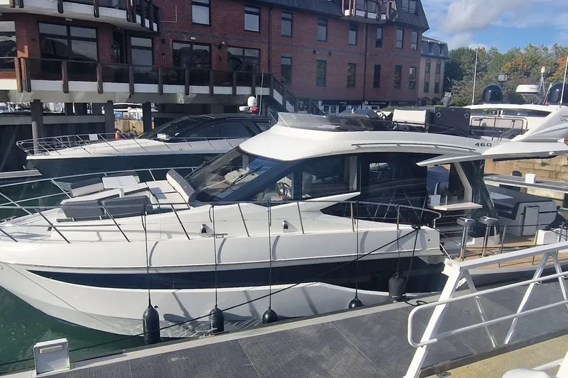 Alouise Yacht Photos Pics 2022 Galeon 460 Fly yacht docked at a marina, featuring sleek design and modern architecture.