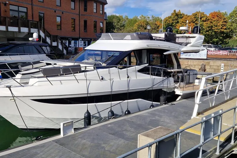 Alouise Yacht Photos Pics 2022 Galeon 460 Fly yacht docked at a marina, showcasing sleek design and modern features.
