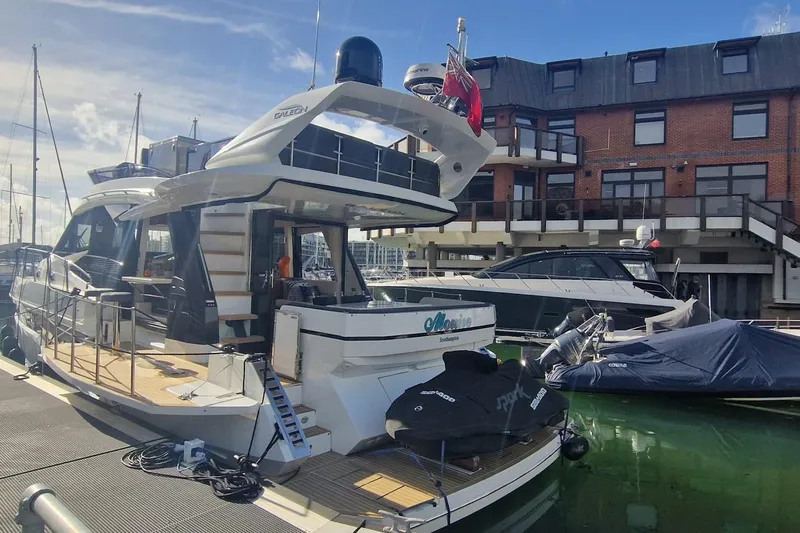 Alouise Yacht Photos Pics 2022 Galeon 460 Fly yacht docked at marina, featuring modern design and spacious deck.