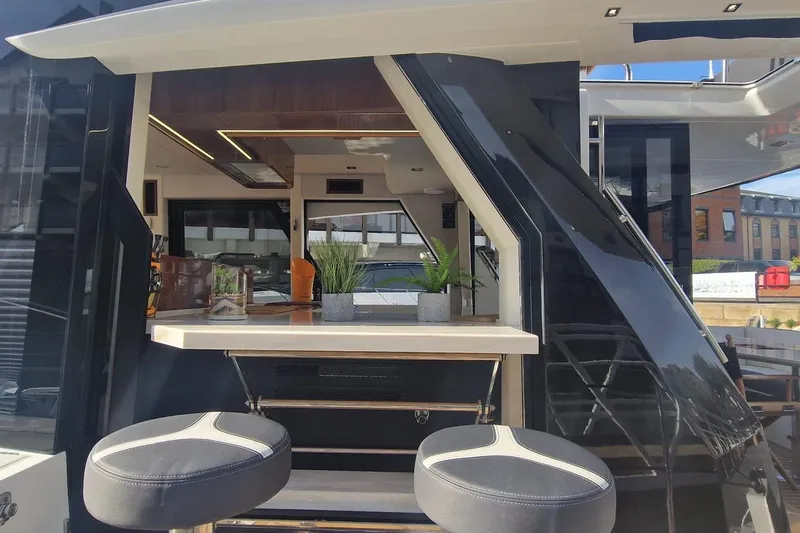 Alouise Yacht Photos Pics Luxury interior of 2022 Galeon 460 Fly yacht with modern bar and seating.
