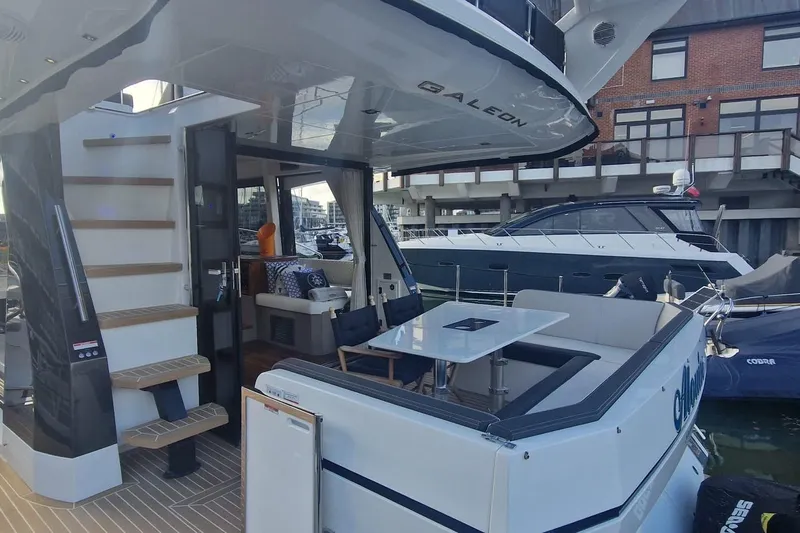 Alouise Yacht Photos Pics 2022 Galeon 460 Fly yacht with modern interior and exterior design at a marina.