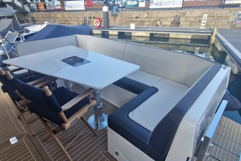 Alouise Yacht Photos Pics Luxury seating area on 2022 Galeon 460 Fly yacht with table and chairs.