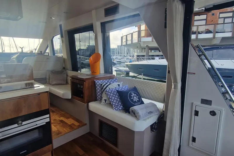 Alouise Yacht Photos Pics Luxurious interior of 2022 Galeon 460 Fly yacht with elegant seating and marina view.