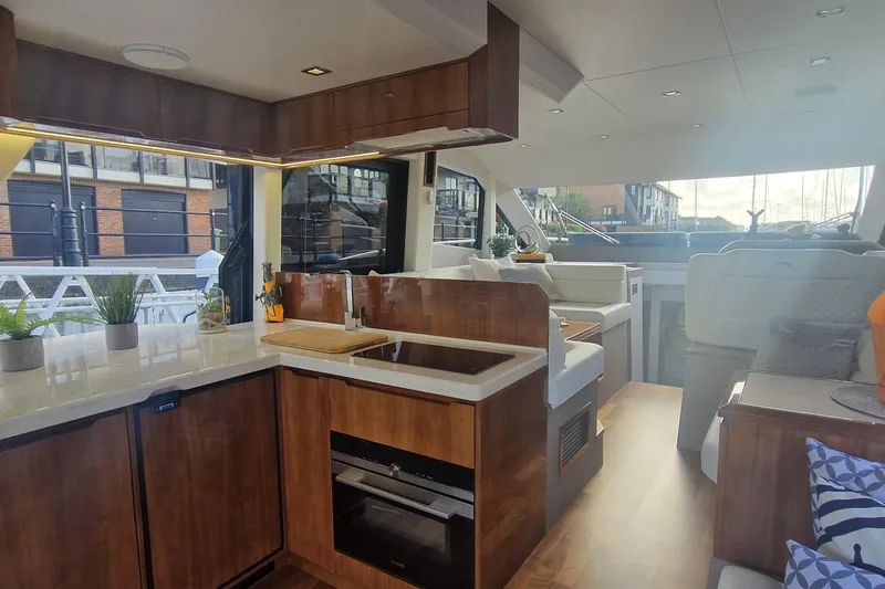Alouise Yacht Photos Pics Luxurious interior of 2022 Galeon 460 Fly yacht with modern kitchen and seating area.