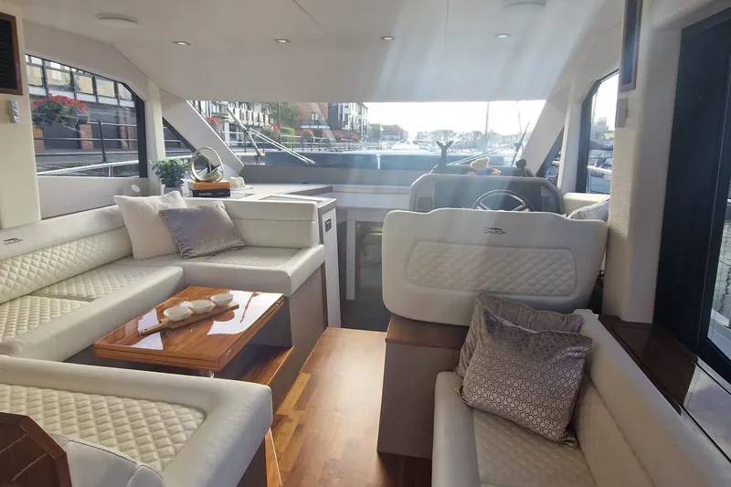 Alouise Yacht Photos Pics Luxurious interior of 2022 Galeon 460 Fly yacht with elegant seating and helm station.