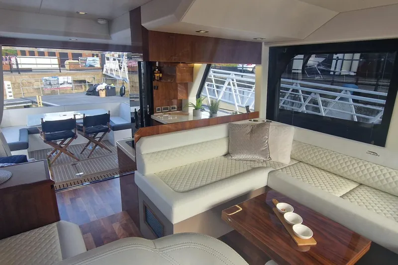 Alouise Yacht Photos Pics Luxurious interior of 2022 Galeon 460 Fly yacht with elegant seating and dining area.