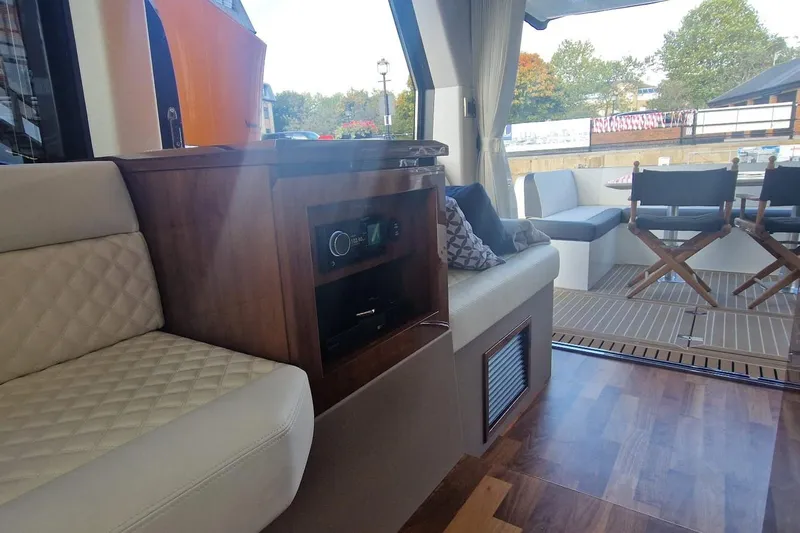 Alouise Yacht Photos Pics Luxurious interior of 2022 Galeon 460 Fly yacht with elegant seating and wood accents.