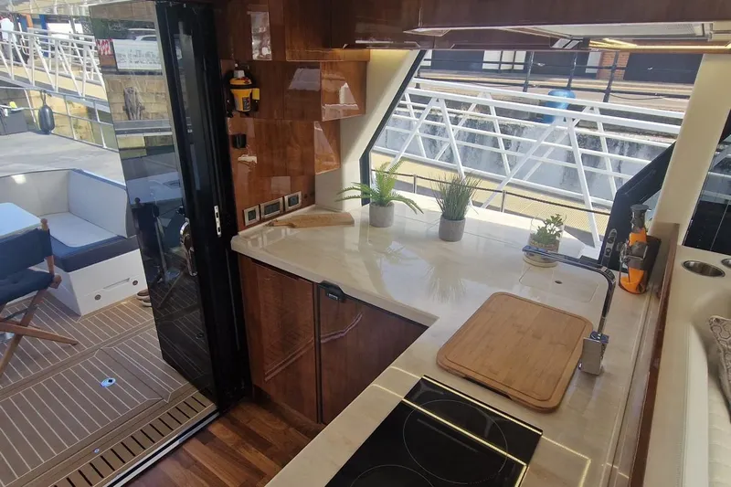 Alouise Yacht Photos Pics Modern kitchen interior on 2022 Galeon 460 Fly yacht, featuring sleek countertops and potted plants.