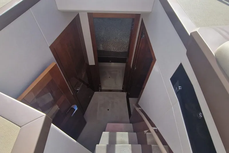 Alouise Yacht Photos Pics Interior staircase of 2022 Galeon 460 Fly yacht, featuring sleek wooden doors and modern design.