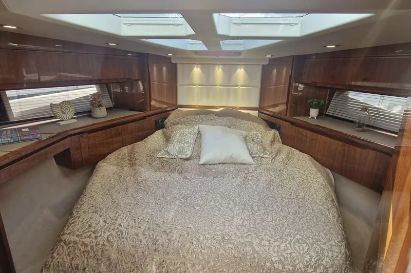 Alouise Yacht Photos Pics Luxurious bedroom interior of 2022 Galeon 460 Fly yacht with elegant bedding and skylights.