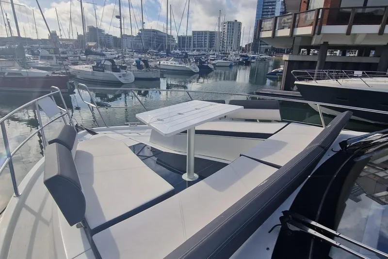 Alouise Yacht Photos Pics Luxurious 2022 Galeon 460 Fly yacht with spacious deck seating in a marina setting.