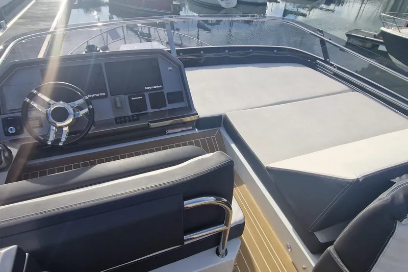 Alouise Yacht Photos Pics 2022 Galeon 460 Fly yacht helm with Raymarine navigation, sleek design, and waterfront view.