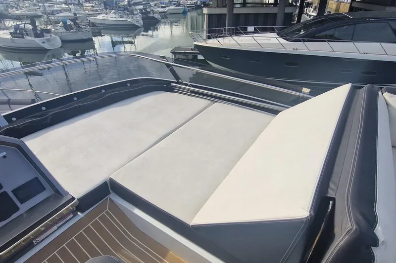 Alouise Yacht Photos Pics 2022 Galeon 460 Fly yacht with spacious sunbathing area in a marina setting.