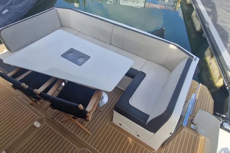 Alouise Yacht Photos Pics Luxury seating area on 2022 Galeon 460 Fly yacht, featuring elegant table and chairs.