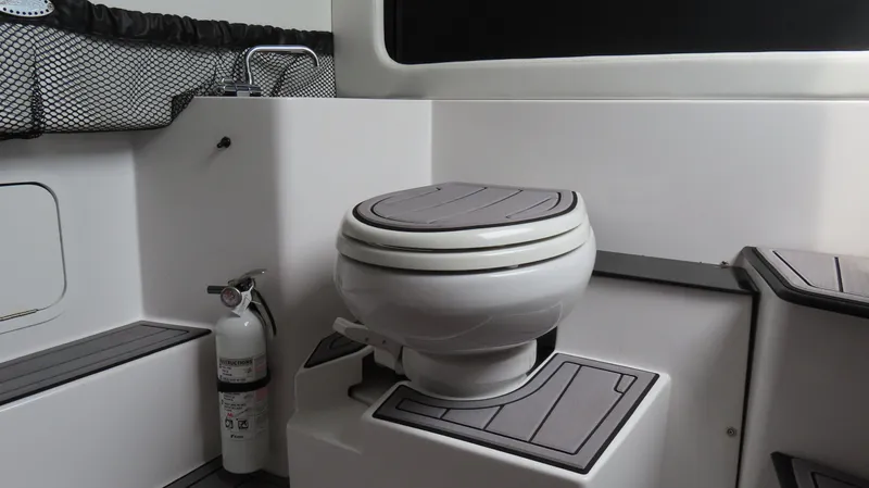  Yacht Photos Pics 2023 Nor-Tech 390 Sport Center Console boat interior with toilet and fire extinguisher.