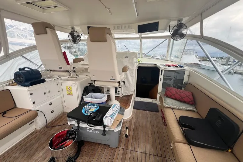  Yacht Photos Pics 1999 Ocean Yachts 48 Express interior with seating, helm, and marina view.