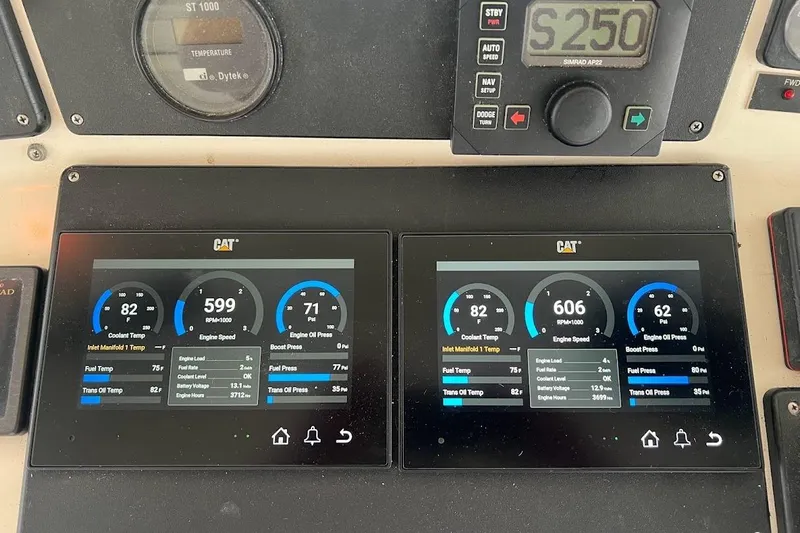  Yacht Photos Pics Dashboard of a 1999 Ocean Yachts 48 Express showing engine metrics and controls.