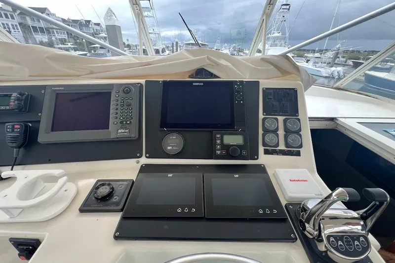  Yacht Photos Pics 1999 Ocean Yachts 48 Express helm with navigation equipment and controls, docked at marina.