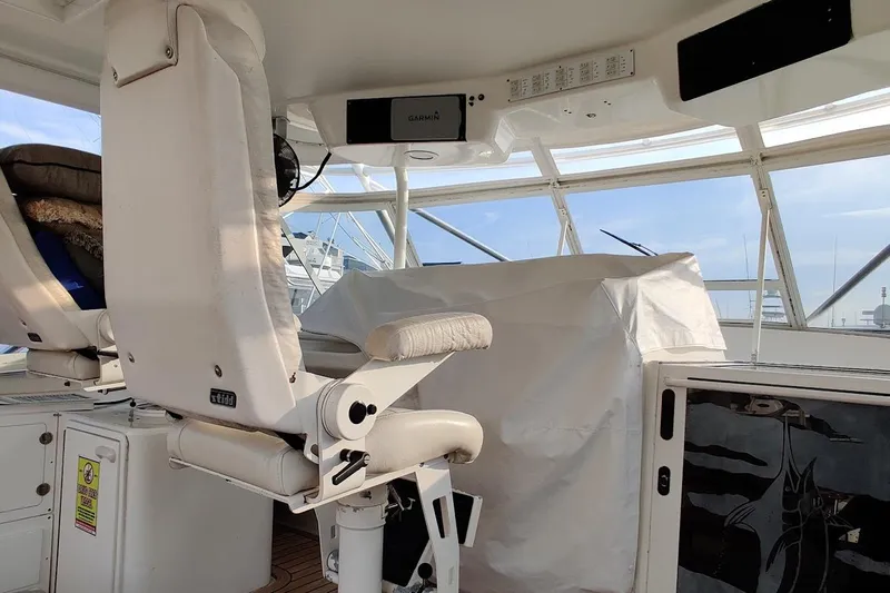  Yacht Photos Pics 1999 Ocean Yachts 48 Express helm with white seating and navigation equipment.