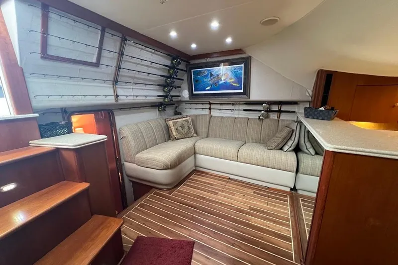  Yacht Photos Pics Luxurious 1999 Ocean Yachts 48 Express interior with cozy seating and elegant wood flooring.