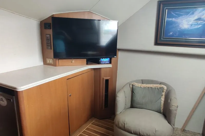  Yacht Photos Pics Interior of 1999 Ocean Yachts 48 Express with TV, chair, and artwork.