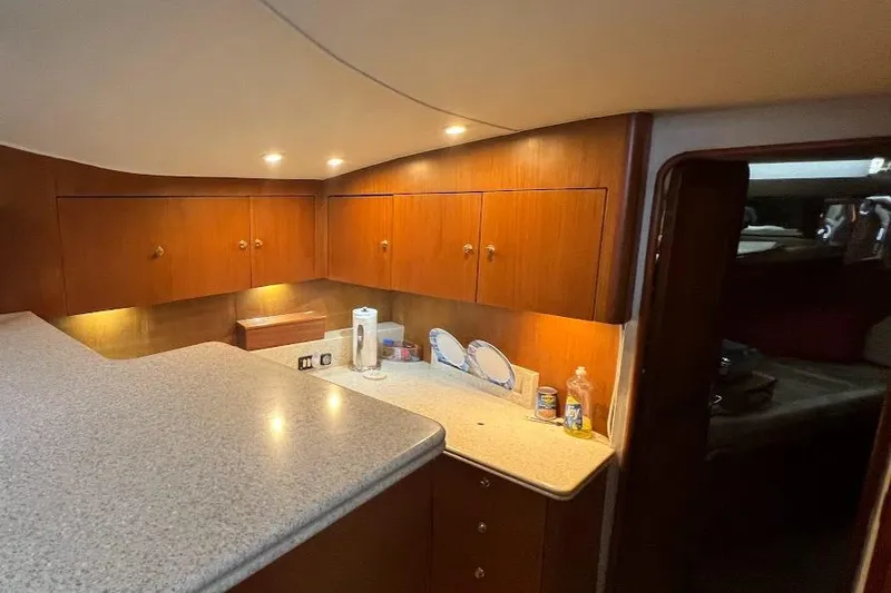 Yacht Photos Pics Interior of 1999 Ocean Yachts 48 Express with wooden cabinets and countertop.