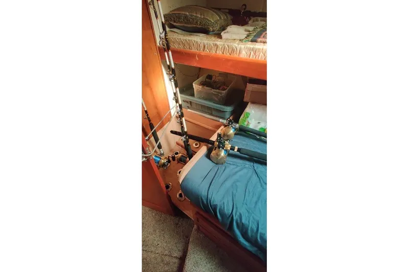  Yacht Photos Pics Interior of 1999 Ocean Yachts 48 Express with fishing rods and bunk beds.