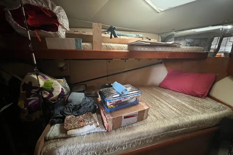  Yacht Photos Pics 1999 Ocean Yachts 48 Express cabin with bunk beds and storage items.