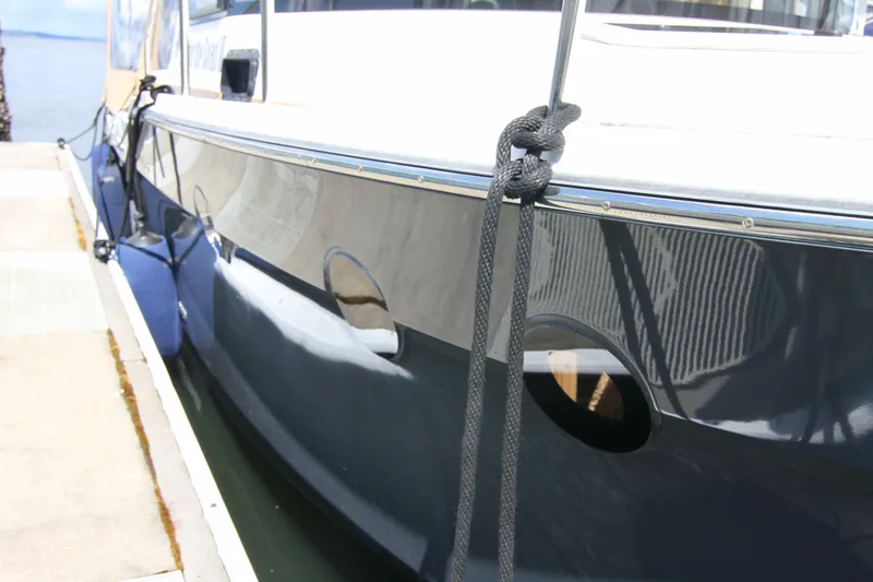  Yacht Photos Pics 2020 Ranger Tugs R-29 boat docked, close-up of hull and mooring lines.